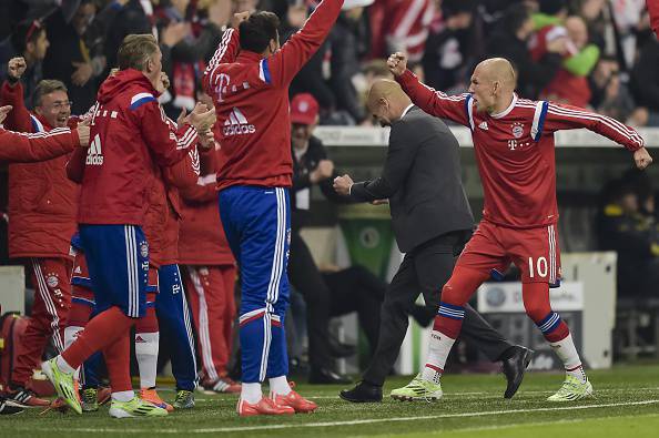 Bayern Munich's Dutch midfielder Arjen Robben (R) celebrates the 1-0 goal during the German Cup DFB Pokal semi-final football match FC Bayern Munich v Borussia Dortmund in Munich, southern Germany, on April 28, 2015.  AFP PHOTO / GUENTER SCHIFFMANN    +++ RESTRICTIONS / EMBARGO  ACCORDING TO DFB RULES IMAGE SEQUENCES TO SIMULATE VIDEO IS NOT ALLOWED DURING MATCH TIME. MOBILE (MMS) USE IS NOT ALLOWED DURING AND FOR FURTHER TWO HOURS AFTER THE MATCH. FOR MORE INFORMATION CONTACT DFB DIRECTLY AT +49 69 67880        (Photo credit should read GUENTER SCHIFFMANN/AFP/Getty Images)