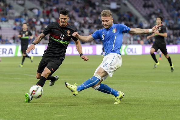 Portugal's defender Jose Fonte (L) and Italy's forward Ciro Immobile vies for the ball during the friendly game Portugal against Italy on the Stade de Geneve on June 16, 2015 in Geneva.  AFP PHOTO / FABRICE COFFRINI        (Photo credit should read FABRICE COFFRINI/AFP/Getty Images)