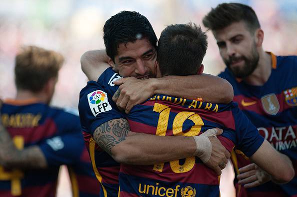 Barcelona's Uruguayan forward Luis Suarez (L) celebrates with Barcelona's defender Jordi Alba (R) after scoring during the Spanish league football match Granada FC vs FC Barcelona at Nuevo Los Carmenes stadium in Granada on May 14, 2016. Barcelona sealed their 24th La Liga title as Luis Suarez took his tally for the season to 59 goals with a hat-trick in a 3-0 win at Granada to hold off Real Madrid's late-season surge. / AFP / JORGE GUERRERO (Photo credit should read JORGE GUERRERO/AFP/Getty Images)