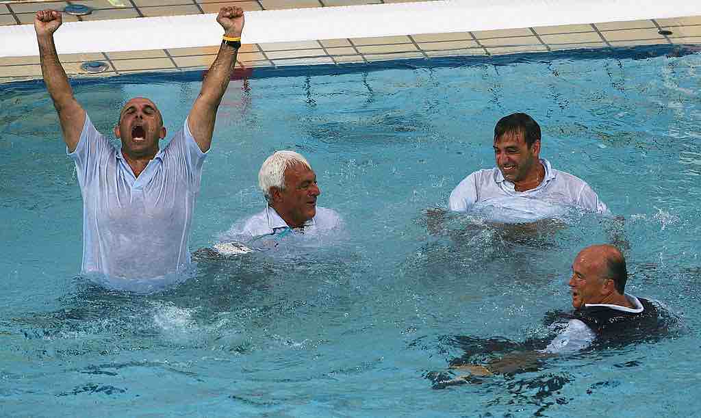 ATHENS - AUGUST 26: The Italian coaching staff celebrate after their extra-time win in the women's Water Polo gold medal game against Greece on August 26, 2004 during the Athens 2004 Summer Olympic